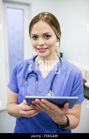 Portrait of vet using digital tablet