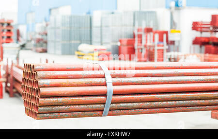 Stack of steel pipes for scaffolding in warehouse Stock Photo