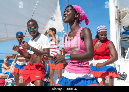 Tourists and entertainer dancing on a excursion catamaran to Isla Saona,   Parque Nacional del Este, Dominican Republic, Carribe Stock Photo