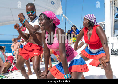 Tourists and entertainer dancing on a excursion catamaran to Isla Saona,   Parque Nacional del Este, Dominican Republic, Carribe Stock Photo