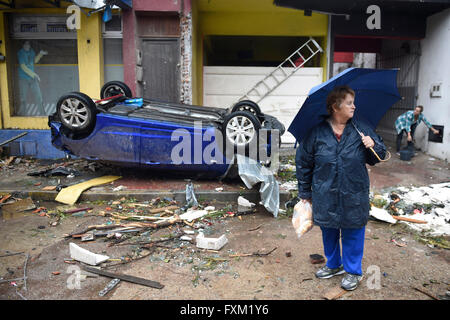 Dolores, Uruguay. 16th Apr, 2016. A woman stands in front of an overturned car after a tornado in Dolores, Uruguay, on April 16, 2016. A tornado thrashed the city of Dolores, western Uruguay, on Friday, leaving four people dead and others seriously injured, the country's emergency services said. Credit:  Nicolas Celaya/Xinhua/Alamy Live News Stock Photo