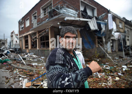 Dolores, Uruguay. 16th Apr, 2016. A man walks in front of damage buildings after a tornado in Dolores, Uruguay, on April 16, 2016. A tornado thrashed the city of Dolores, western Uruguay, on Friday, leaving four people dead and others seriously injured, the country's emergency services said. Credit:  Nicolas Celaya/Xinhua/Alamy Live News Stock Photo