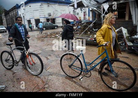 Dolores, Uruguay. 16th Apr, 2016. People walk in front of damage buildings after a tornado in Dolores, Uruguay, on April 16, 2016. A tornado thrashed the city of Dolores, western Uruguay, on Friday, leaving four people dead and others seriously injured, the country's emergency services said. Credit:  Nicolas Celaya/Xinhua/Alamy Live News Stock Photo