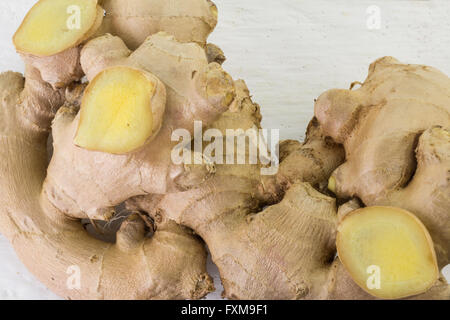 Whole ginger root and cut slices isolated on white Stock Photo