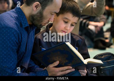 Member of the children's contest of readers the Koran holy book is preparing for the competition in the hall of Moscow Mosque Stock Photo