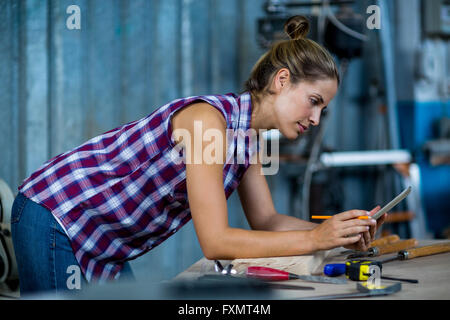 Female carpenter using digital tablet Stock Photo