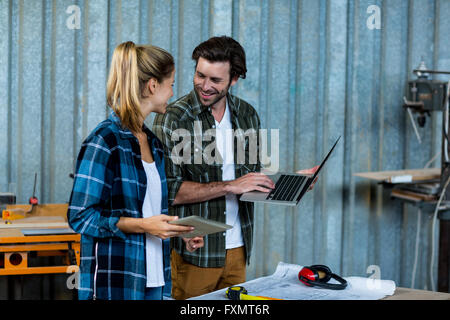 Carpenters using digital tablet and laptop Stock Photo