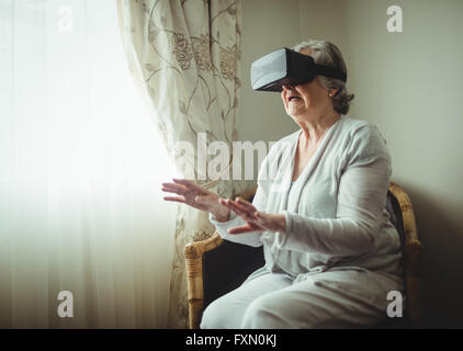 Senior woman using an oculus rift Stock Photo