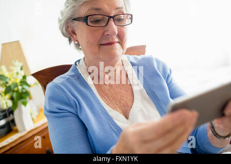Senior woman using a smartphone Stock Photo