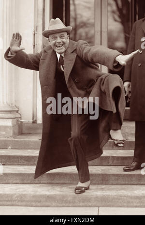 Billy Sunday, popular baseball player in the late 19th century and the most influential American evangelist during the first two decades of the 20th century, striking a 'pitching' pose on the steps of the White House on February 20, 1922. Stock Photo