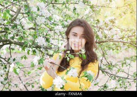 Portrait of young woman in flowered garden Stock Photo