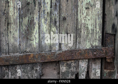 Rusty iron hinge on rotten wood Stock Photo
