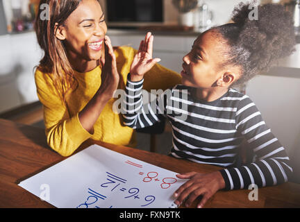 Learning to calculate, high five success, black mother and child Stock Photo