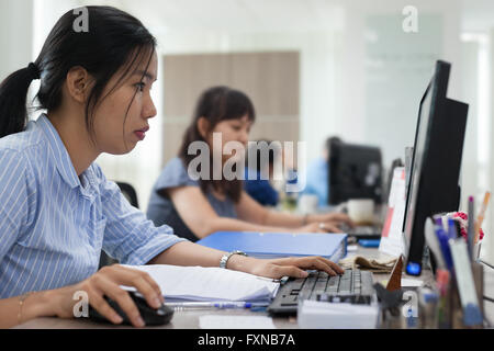 Asian businesswomen working computer sitting office Stock Photo