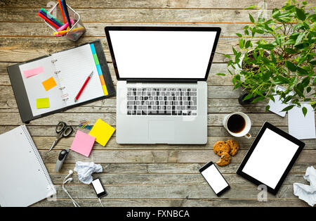 Laptop with other modern electonic devices on desk Stock Photo