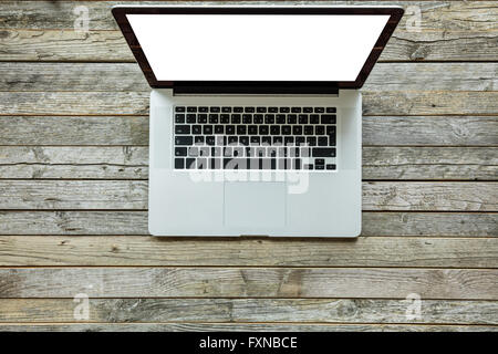 Modern designed laptop on old wooden desk Stock Photo