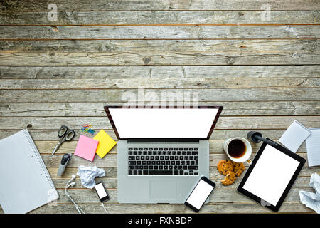 Laptop with other modern electonic devices on desk Stock Photo