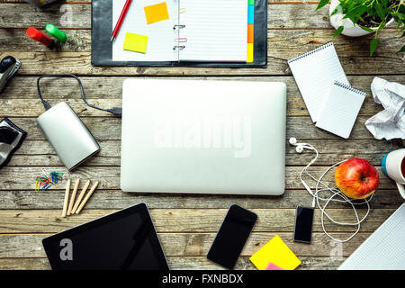 Laptop with other modern electonic devices on desk Stock Photo