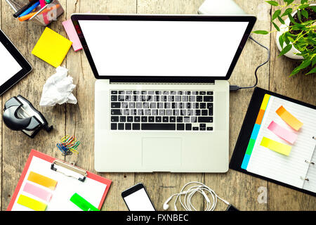 Laptop with other modern electonic devices on desk Stock Photo