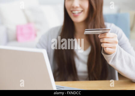 Young attractive Japanese woman doing online shopping at home Stock Photo
