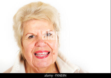 Blonde hair mature woman in her 70's smiling at the camera. Stock Photo