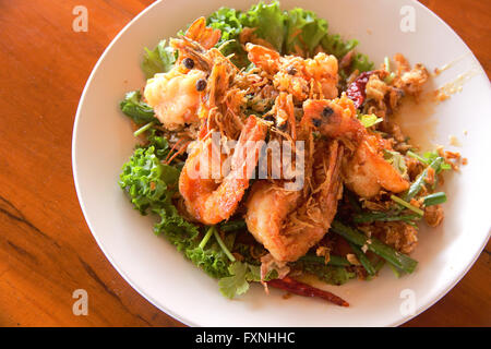 Fried Shrimp with tamarind sauce.Thai food on wooden table. Stock Photo