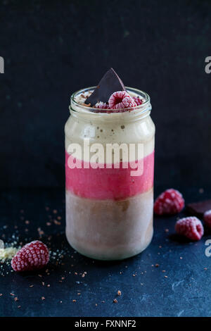 Banana, cocoa, raspberry smoothie with almond milk Stock Photo