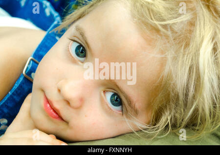 Blue eyed cute little girl close up Stock Photo