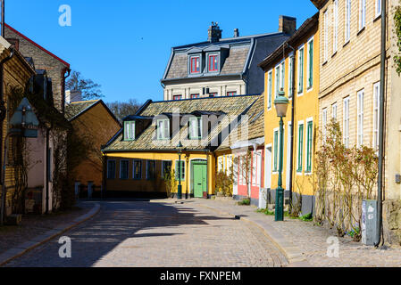 Lund, Sweden - April 11, 2016: Charming street view in yellow and pink from Lund. Stock Photo
