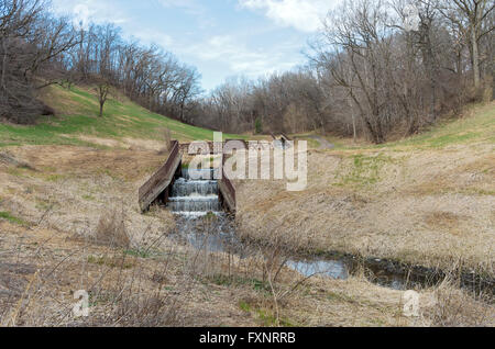 battle creek regional park scenic with footbridge crossing stream running along tree lined trail with dam in foreground in saint Stock Photo