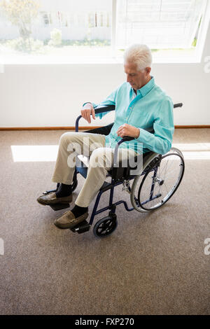 Senior man sitting in a wheelchair Stock Photo