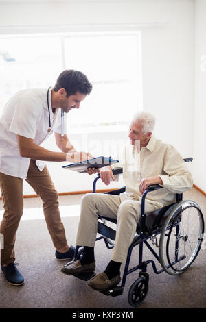 Nurse showing senior man a document Stock Photo