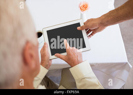Senior man using a tablet Stock Photo