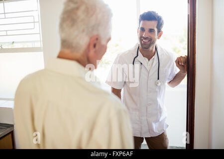 Nurse visiting senior man Stock Photo