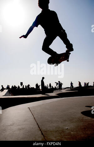 Skateboarder in midair at skate park Stock Photo