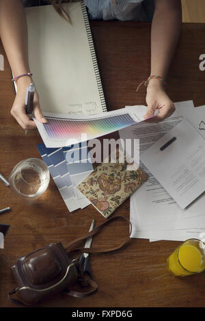 Woman looking at color spectrum sheet Stock Photo