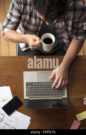Man at desk using laptop Stock Photo