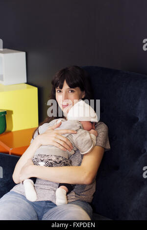 Mother holding sleeping infant Stock Photo