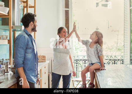 Mother exchanging high five with daughter Stock Photo