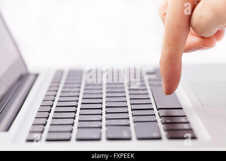 Human hands going to press a button on keypad in white isolated background Stock Photo