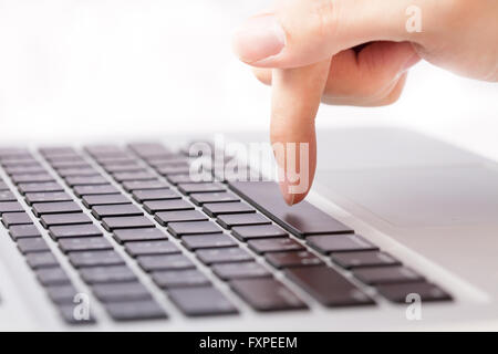 Human hands going to press a button on keypad in white isolated background Stock Photo