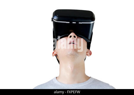 Asian man wearing VR goggle and immersing himself in VR multimedia in white isolated and clipping mask. VR is Virtual Reality Stock Photo