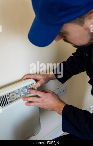 Handyman testing air conditioner Stock Photo