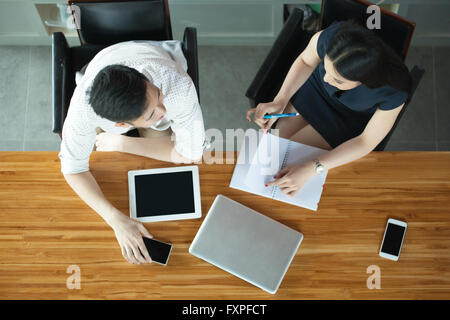 Top View of Business or Creative People Discussing Behind the desk Stock Photo