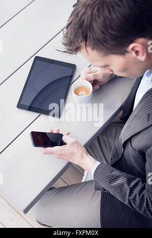 Businessman using Smartphone on office Stock Photo