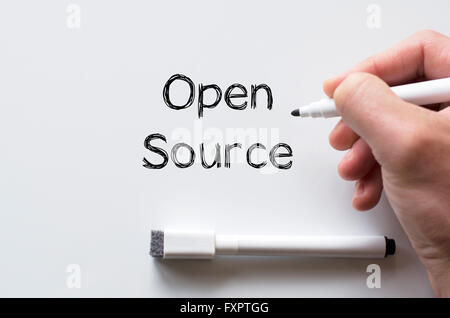 Human hand writing open source on whiteboard Stock Photo