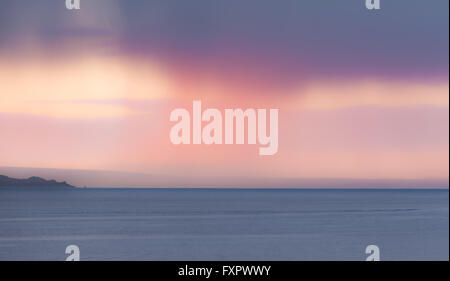 Mousehole, Cornwall, UK. 17th April 2016. UK Weather. Distant rain clouds catching the early morning sunrise over Mounts Bay. Credit:  Simon Maycock/Alamy Live News Stock Photo