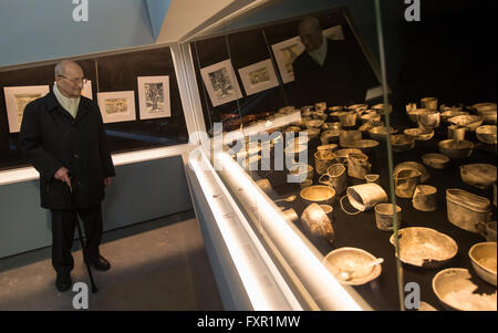 Weimar, Germany. 17th Apr, 2016. Former Buchenwald inmate Bertrand Herz from France looks at exhibits in the overhauled permanent exhibition 'Buchenwald 1937-1945' at the former central building of Buchenwald concentration camp in Weimar, Germany, 17 April 2016. The permanent exhibition which was reopened on the same day spans 2,000 square metres and outlines the history of the concentration camp. Photo: MICHAEL REICHEL/dpa/Alamy Live News Stock Photo