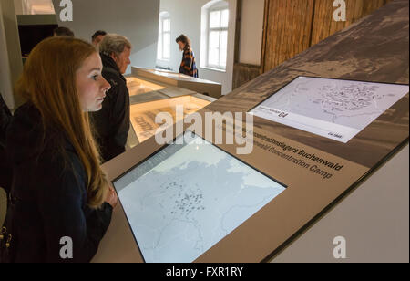 Weimar, Germany. 17th Apr, 2016. A visitor looks at a map in the overhauled permanent exhibition 'Buchenwald 1937-1945' at the former central building of Buchenwald concentration camp in Weimar, Germany, 17 April 2016. The permanent exhibition which was reopened on the same day spans 2,000 square metres and outlines the history of the concentration camp. Photo: MICHAEL REICHEL/dpa/Alamy Live News Stock Photo