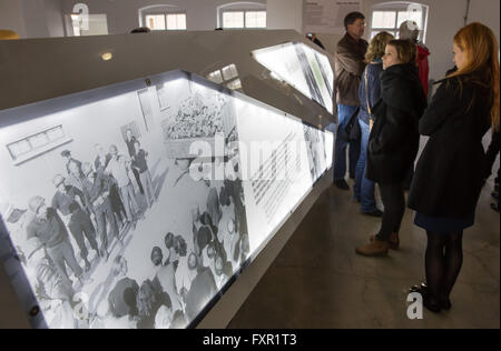 Weimar, Germany. 17th Apr, 2016. Visitors walk through the overhauled permanent exhibition 'Buchenwald 1937-1945' at the former central building of Buchenwald concentration camp in Weimar, Germany, 17 April 2016. The permanent exhibition which was reopened on the same day spans 2,000 square metres and outlines the history of the concentration camp. Photo: MICHAEL REICHEL/dpa/Alamy Live News Stock Photo